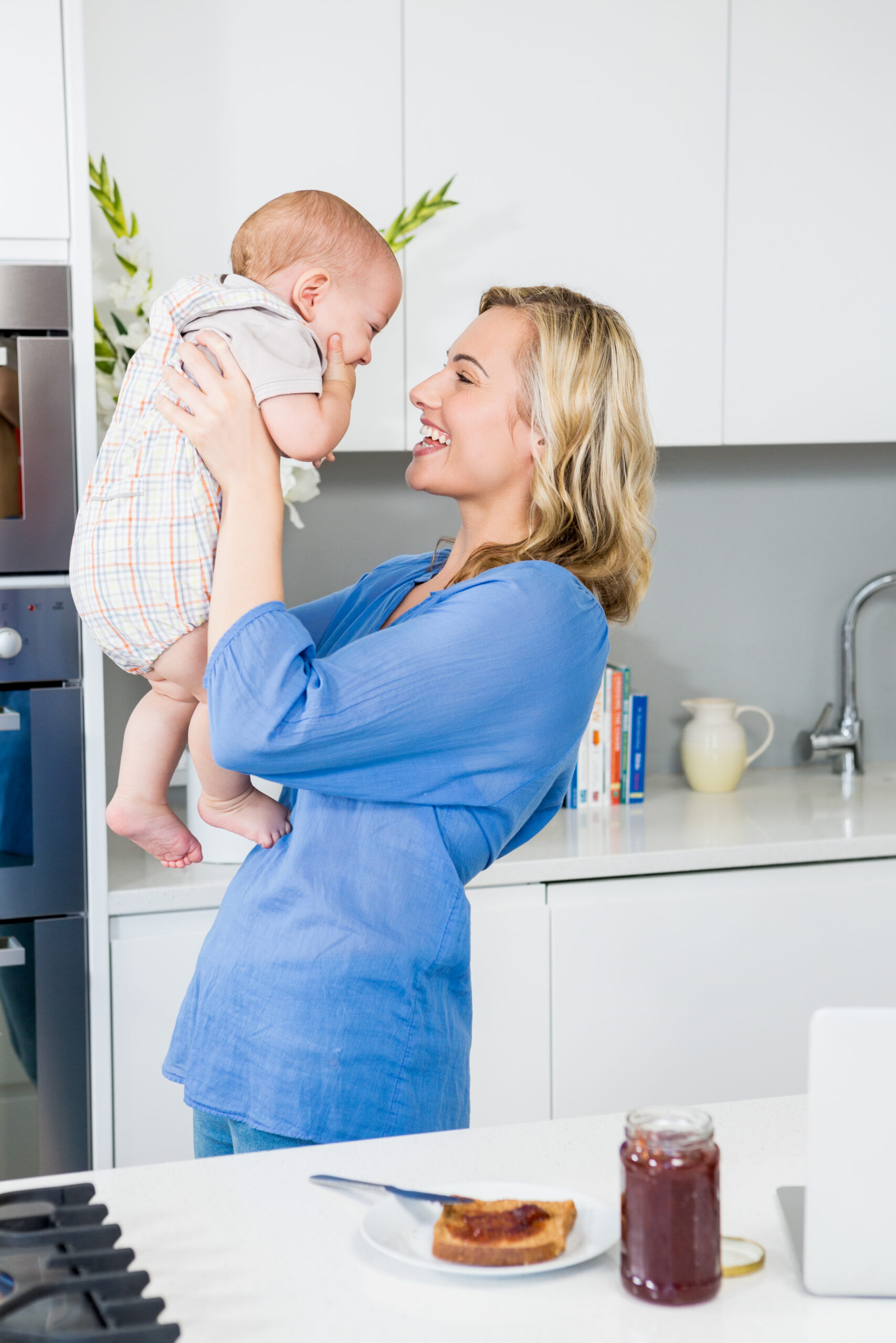 mother holding her baby boy kitchen scaled.jpg